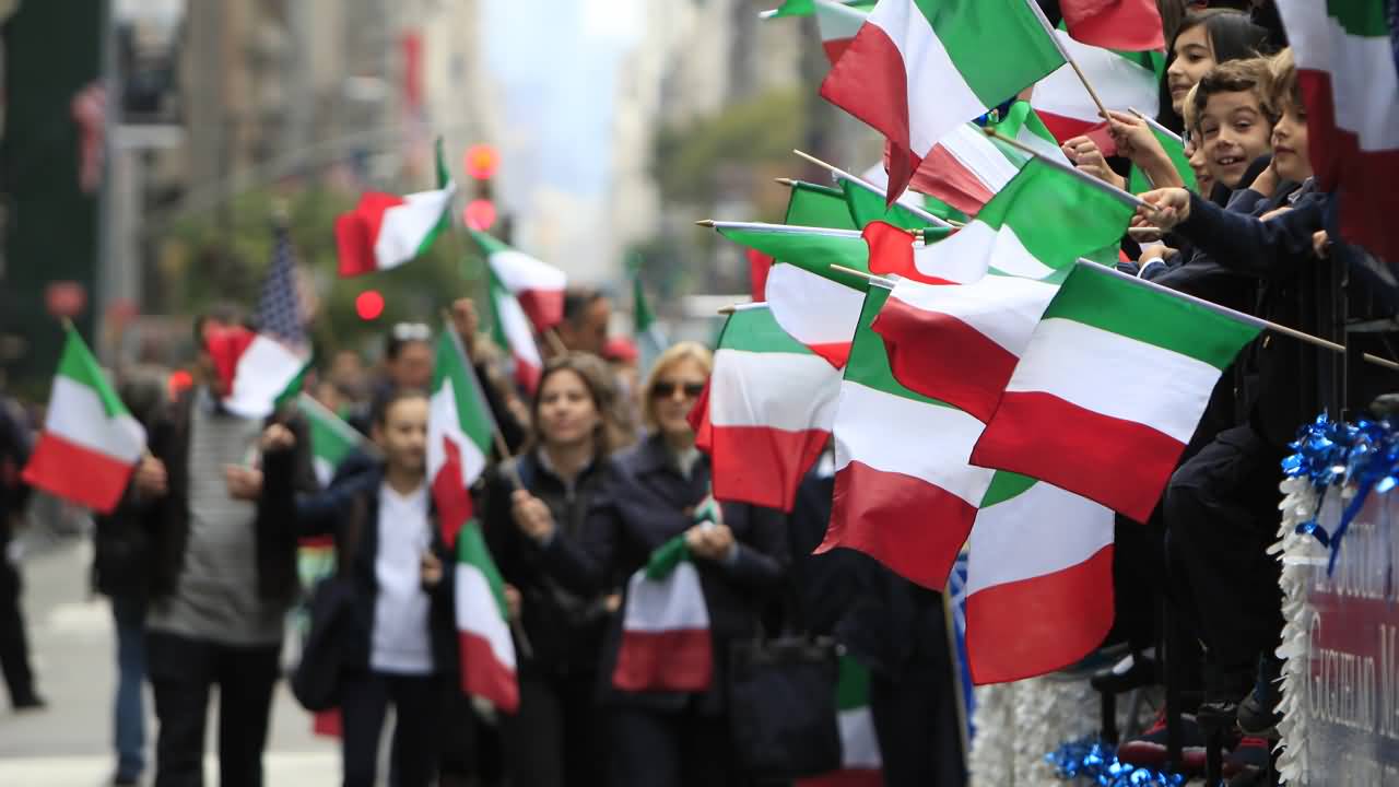 People Waiting For The Columbus Day Parade With Italian Flags In Hand