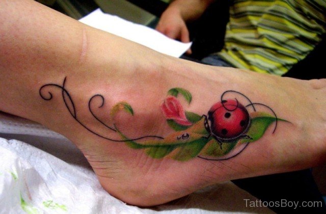 Red Ladybug On Green Leaves Tattoo On Right Foot