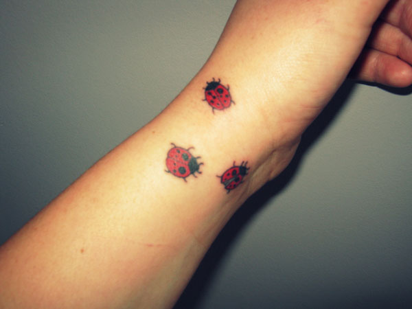 Right Arm Color Ink Ladybug Tattoos On Wrist