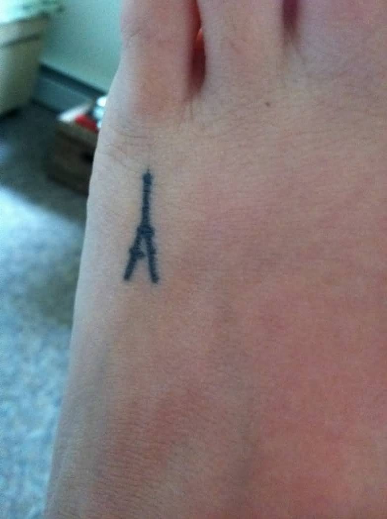 Simple Eiffel Tower Tattoo On Left Foot