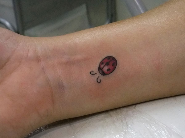 Small Ladybug Tattoo On Right Wrist