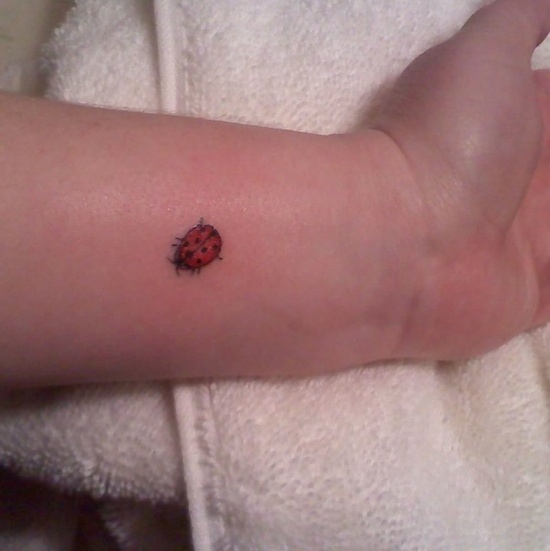 Tiny Ladybug Tattoo On Left Wrist