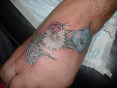 White Daisy Flower And Ladybug Tattoo On Foot