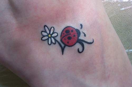 White Flower And Ladybug Tattoo On Foot