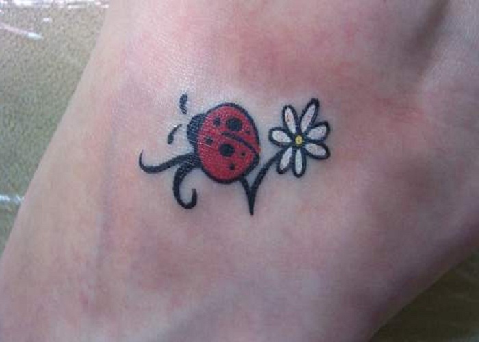 White Flower And Ladybug Tattoo On Left Foot