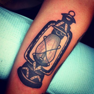 Black Ink Oil Lamp Tattoo On Arm