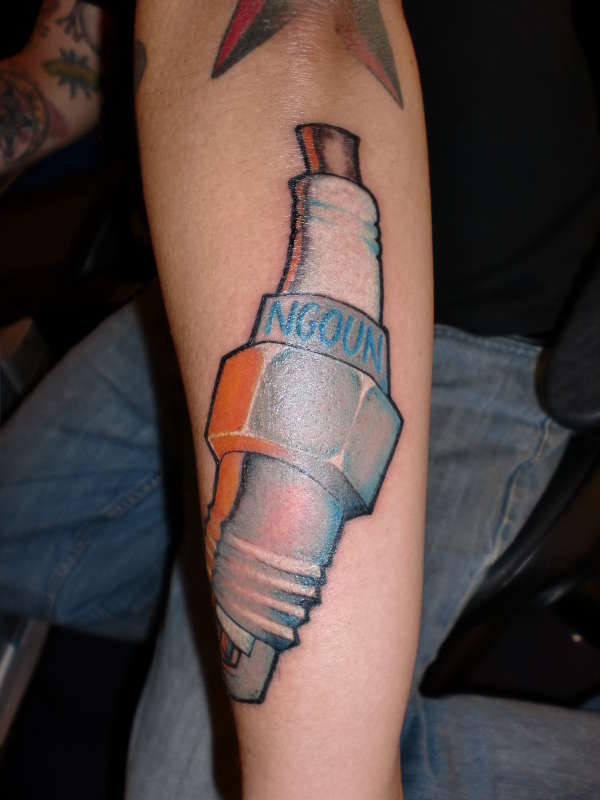 Blue Ink Spark Plug Tattoo On Right Arm