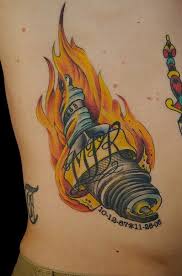 Flaming Spark Plug Tattoo On Side Rib