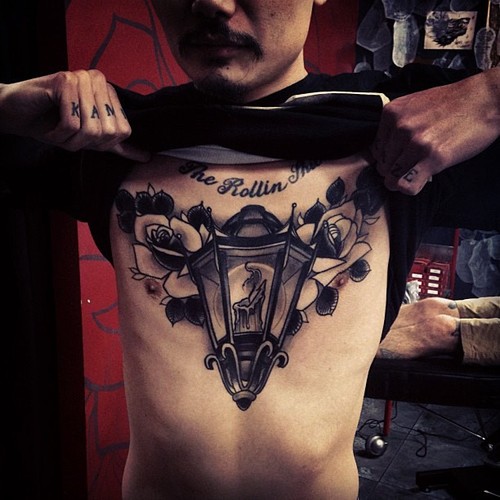 Grey Roses And Lamp Tattoo On Man Chest