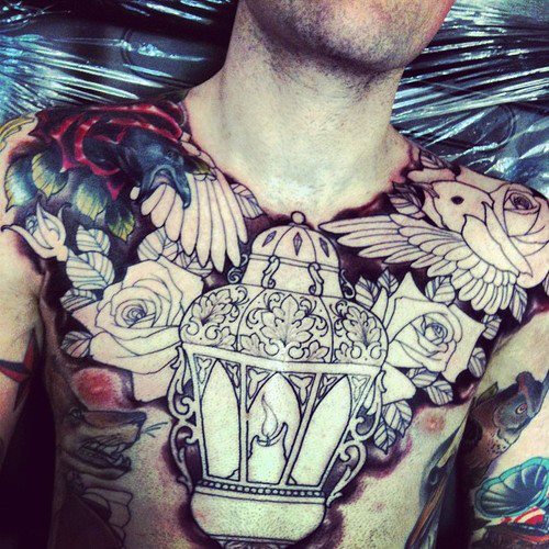Outline Rose And Lamp Tattoo On Man Chest
