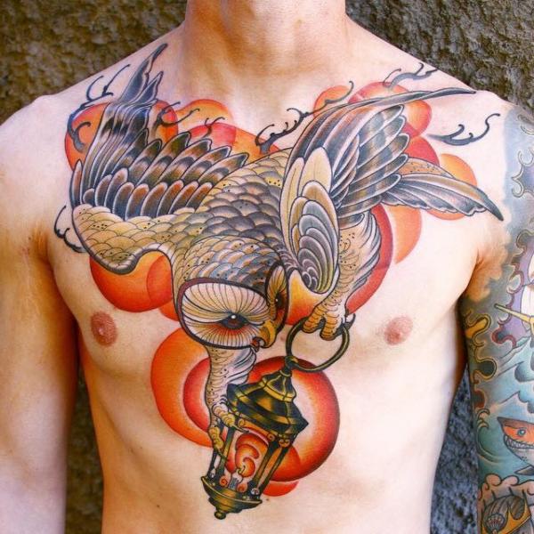Owl Flying With Lamp Tattoo On Man Chest