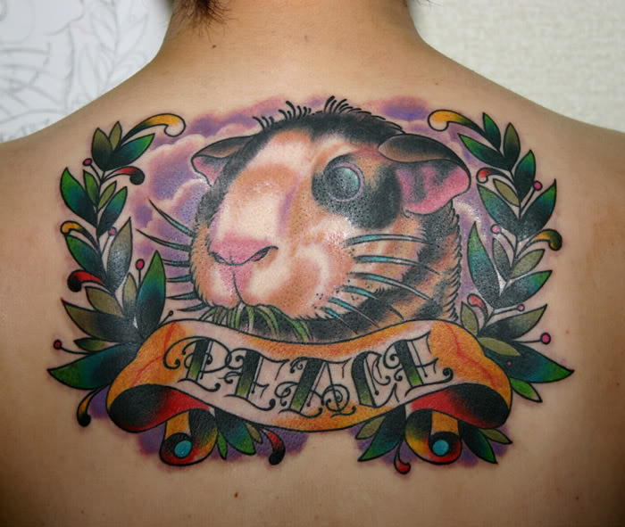 Peace Banner And Hamster Head Tattoo On Upper Back