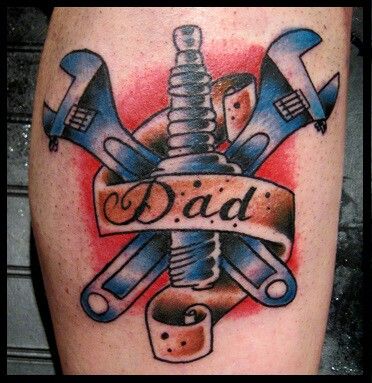 Spanners With Spark Plug And Dad Banner Tattoo On Leg