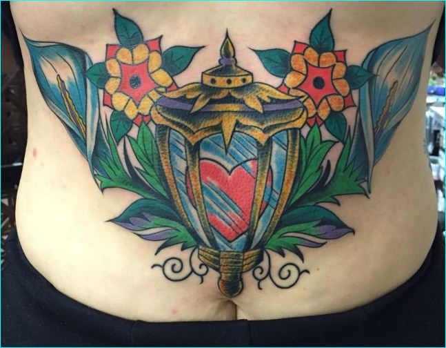 Traditional Flowers And Lamp Tattoo On Lower Back