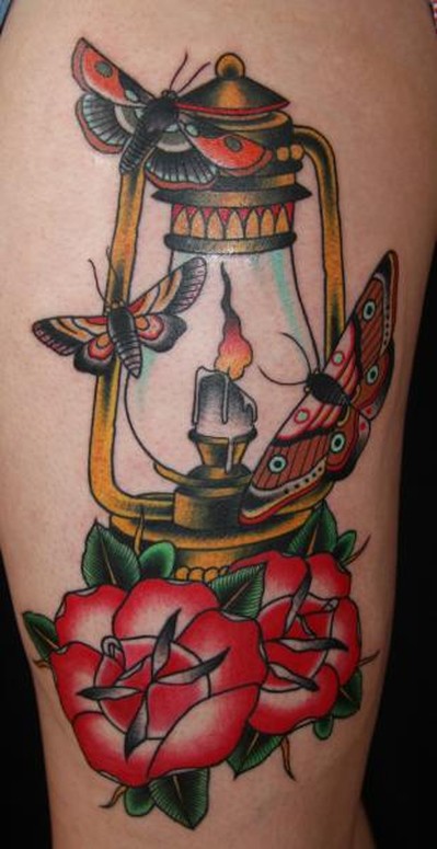 Traditional Flowers And Lamp Tattoo On Sleeve