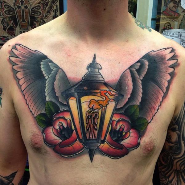 Winged Lamp With Rose Flowers Tattoo On Man Chest