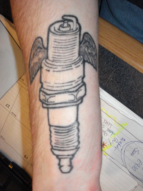Winged Spark Plug Tattoo On Arm