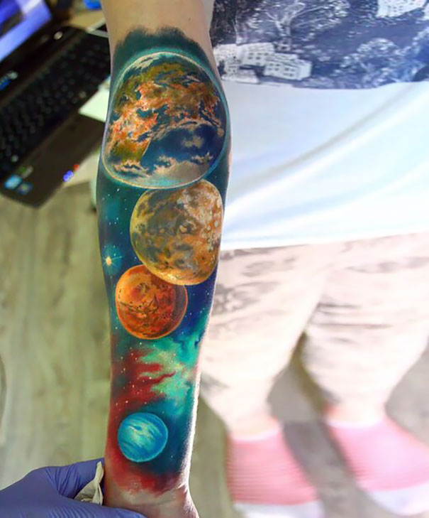 Colored Space Tattoo On Right Forearm