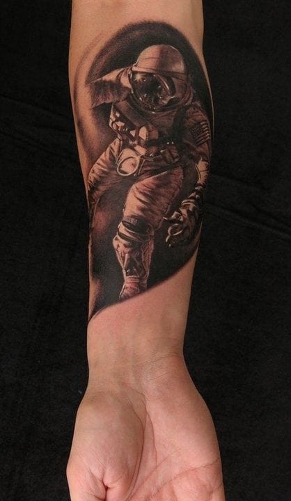 Grey Ink Astronaut Tattoo On Forearm
