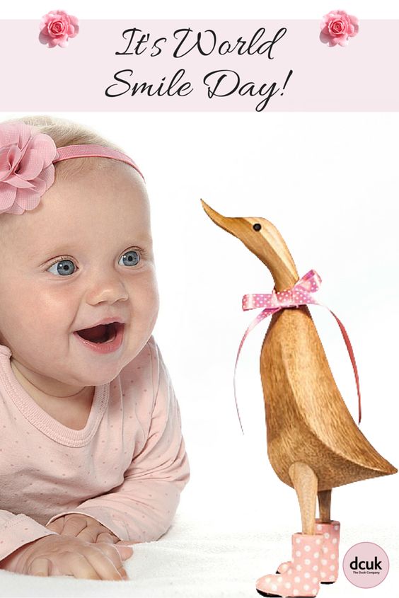 It's World Smile Day Cute Kid Smiling While Looking At Wooden Duck Picture