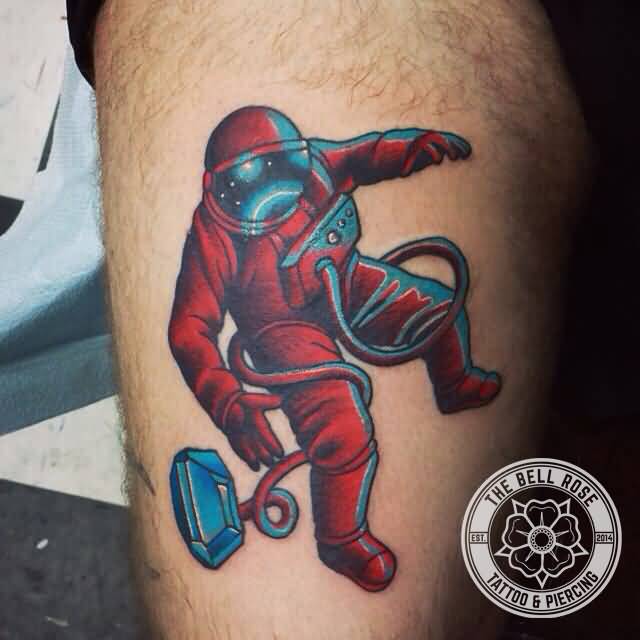 Red And Blue Astronaut Tattoo On Leg