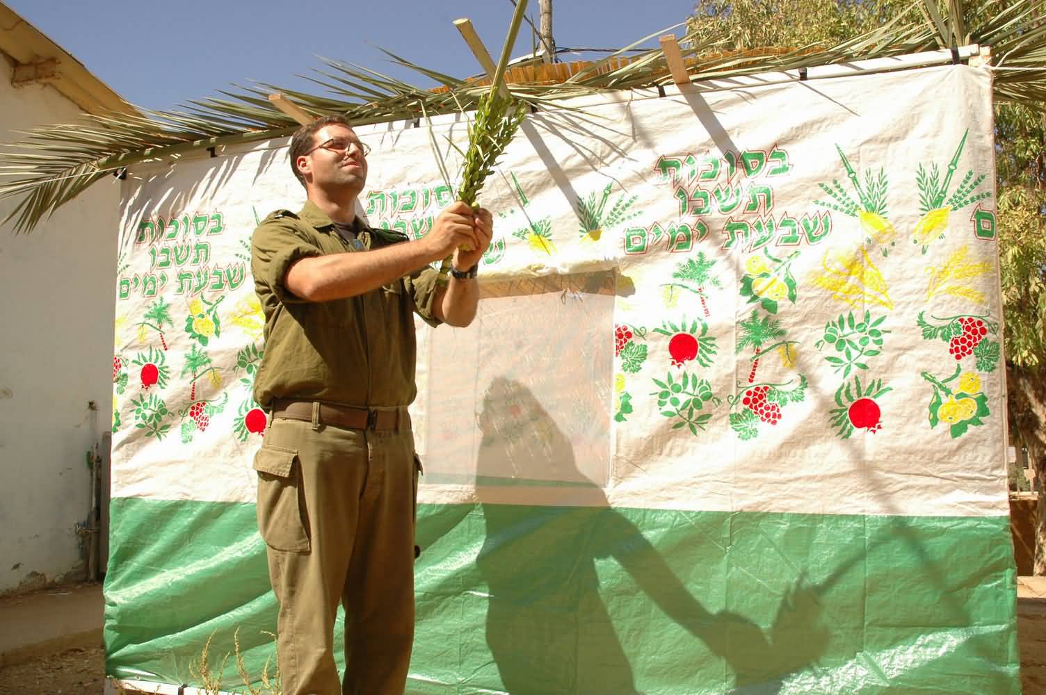 A Jewish Man With Four Species In Hand Praying During Sukkot