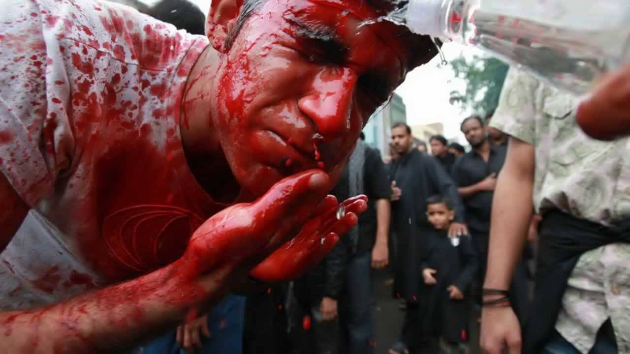 A Muslim Man Washing His Blooded Face During Muharram Celebration