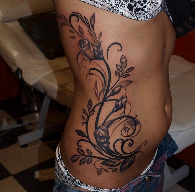 Black And Grey Flowers Tattoo On Side Rib