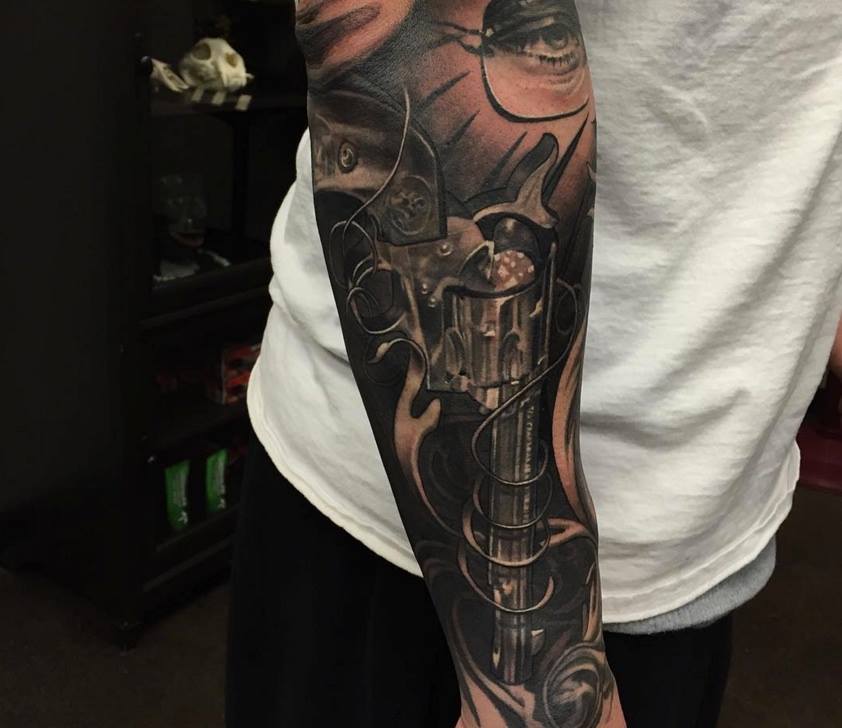 Black And Grey Gun Tattoo On Arm Sleeve by Daniel Rocha