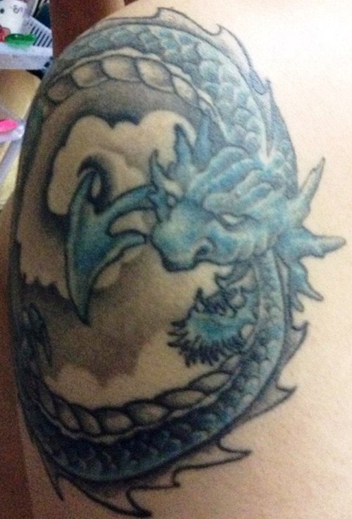 Blue Ink Ouroboros Tattoo On Shoulder