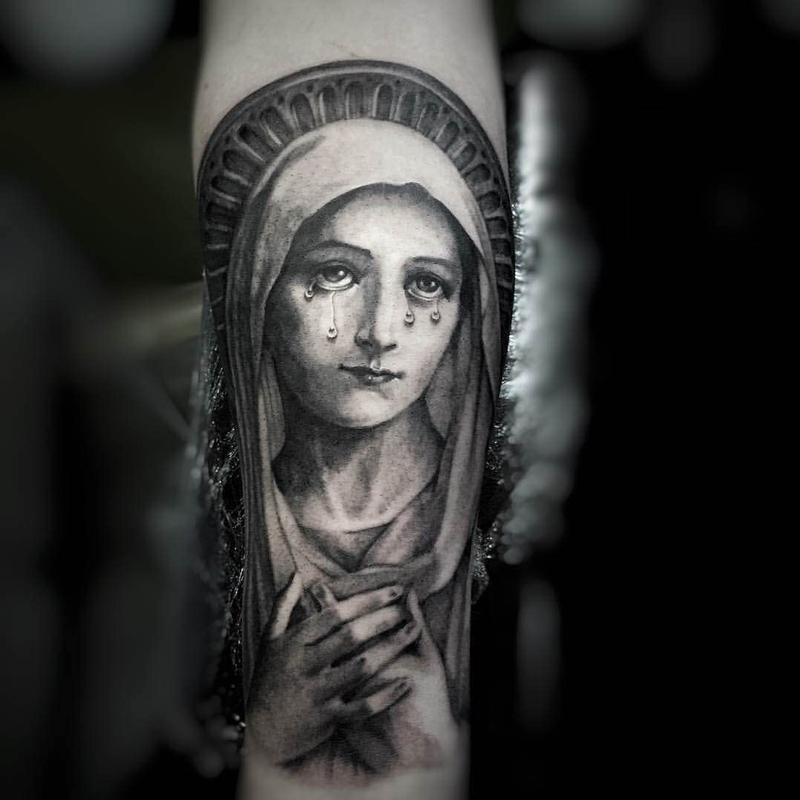 Crying Virgin Mary Tattoo On Forearm.