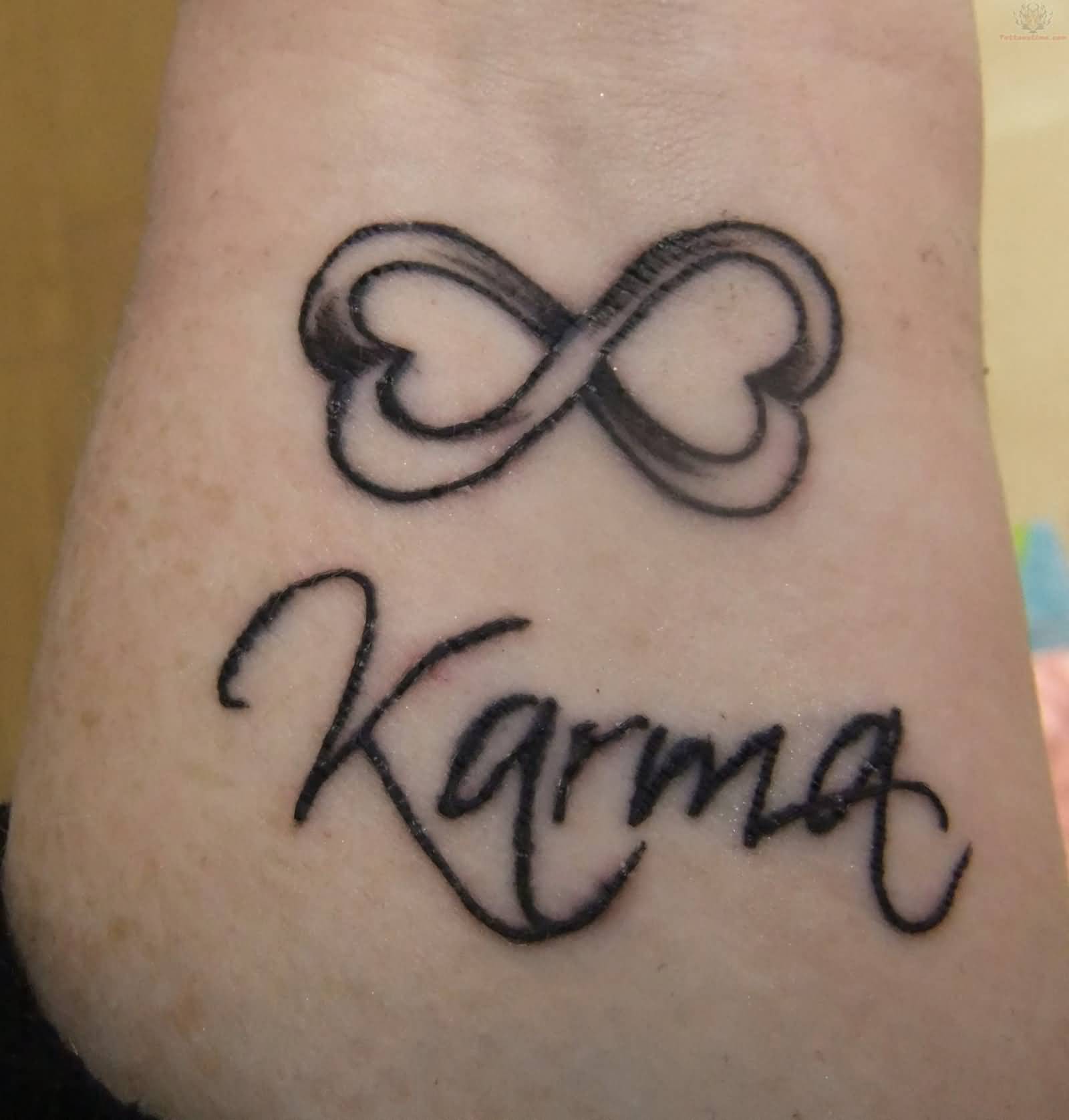 Grey Ink Infinity Karma Tattoo On Wrist