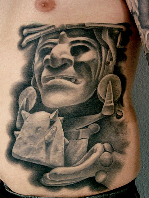 Grey Ink Mayan Tattoo On Man Side Rib