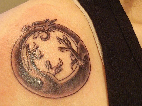 Grey Ink Ouroboros Tattoo On Front Shoulder