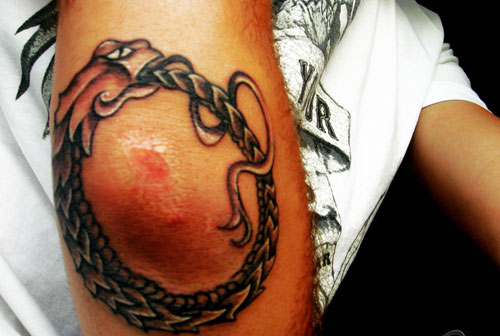 Ouroboros Tattoo On Right Elbow