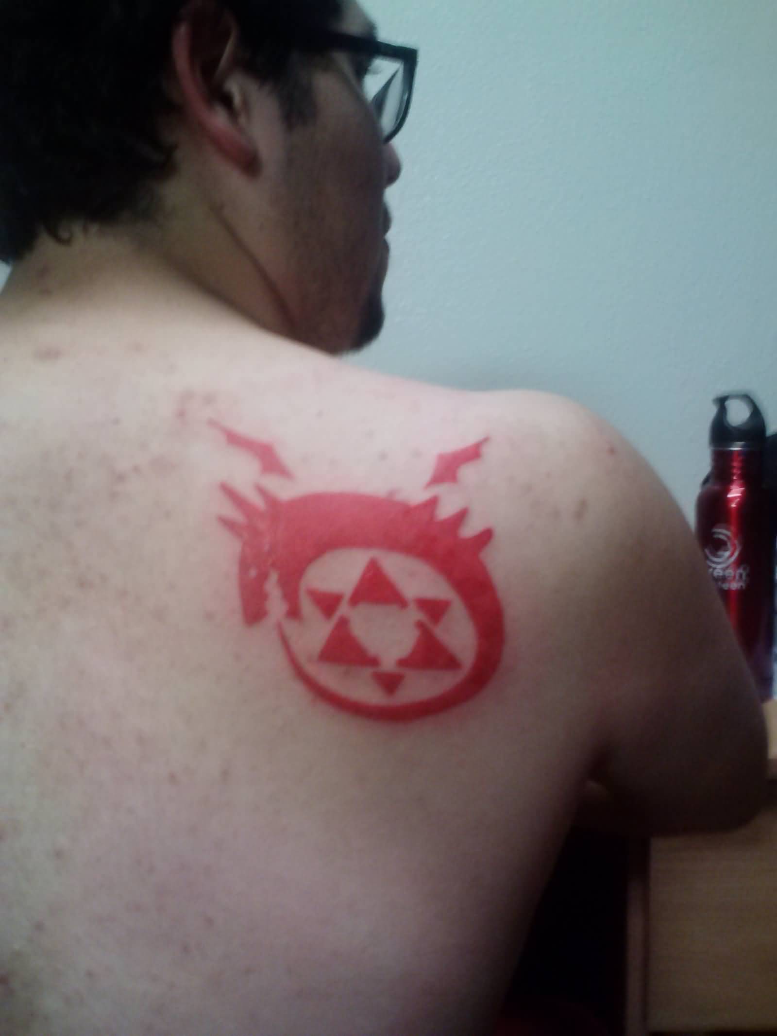 Red Ink Ouroboros Tattoo On Back Shoulder For Men