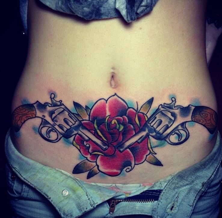 Red Rose And Gun Tattoos On Both Hip by Oracle Tattoo