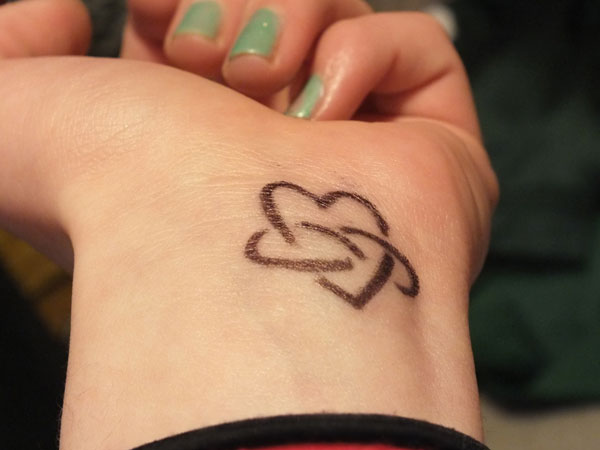 Small Heart And Infinity Tattoo On Girl Wrist