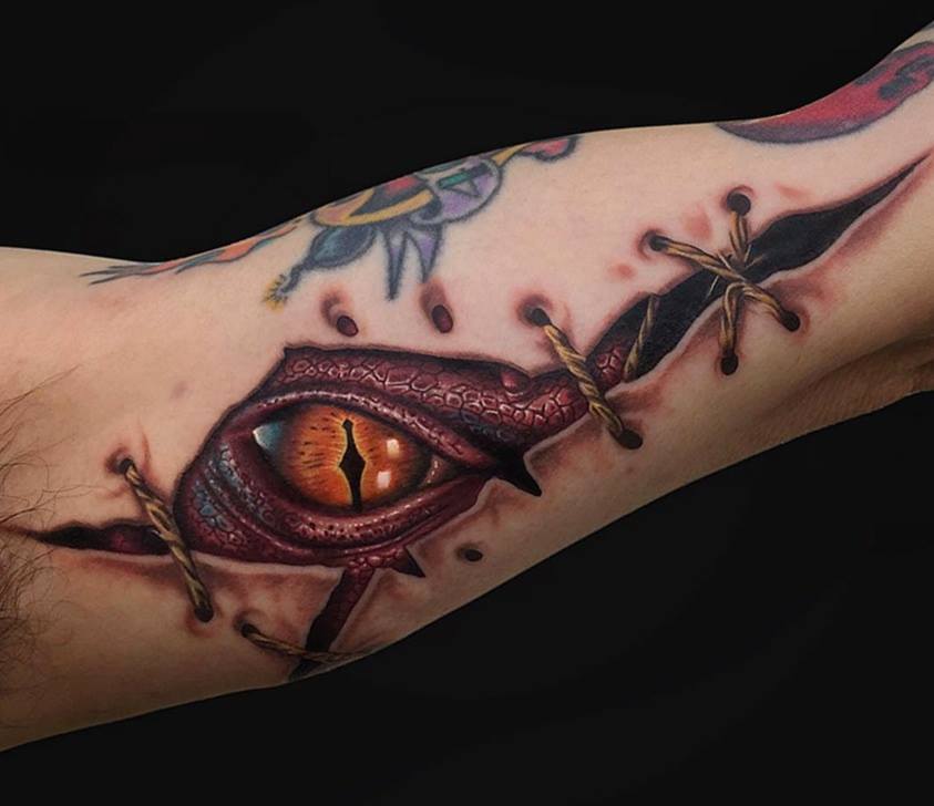 Stiched Torn Skin Tattoo On Bicep by Marc Durrant
