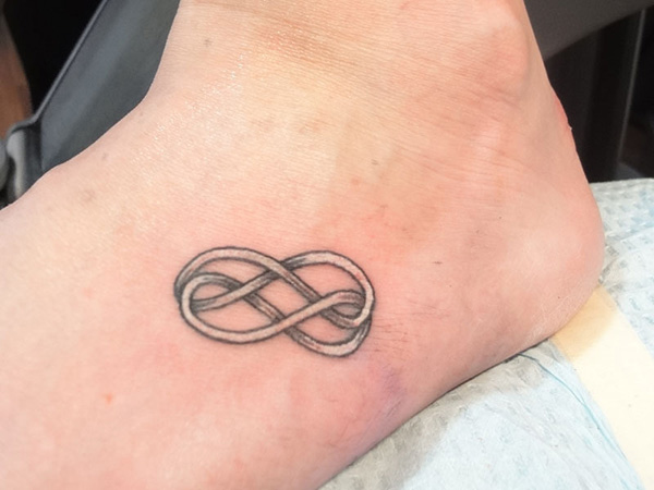 White Infinity Tattoo On Left Foot