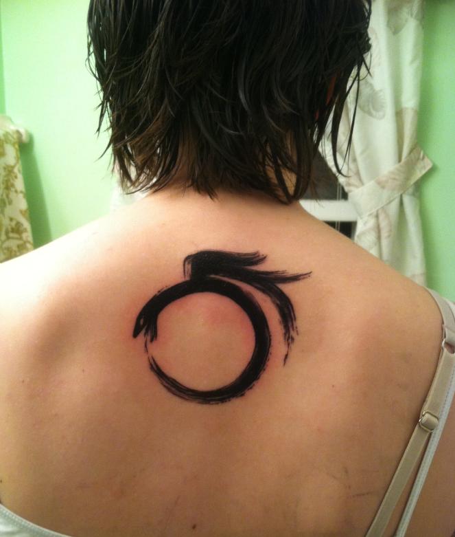 Winged Ouroboros Tattoo On Upper Back