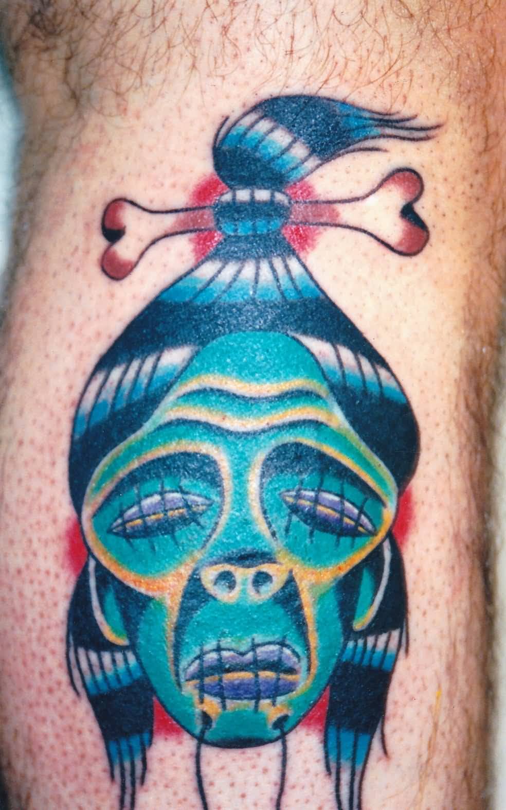 Blue Shrunken Head Tattoo On Calf