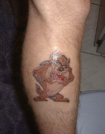 Brown Ink Taz Tattoo On Leg