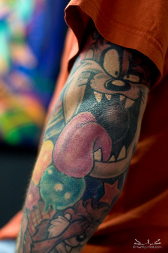 Colored Taz Tattoo On Left Sleeve