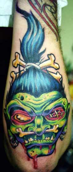 Colorful Shrunken Head Tattoo On Left Forearm by Orrin Hurley
