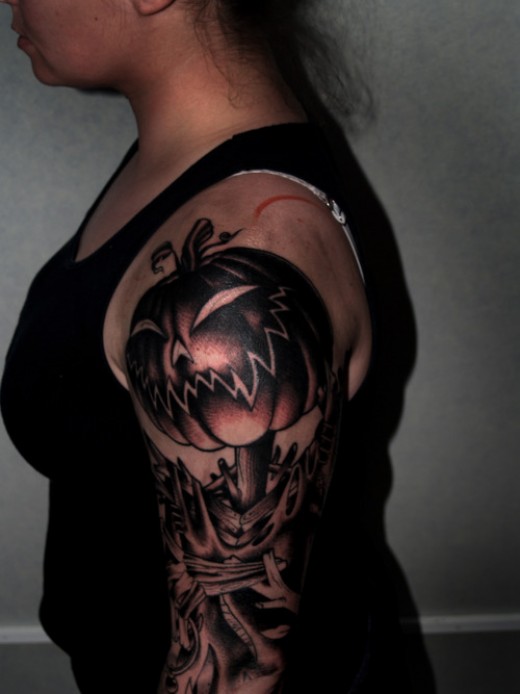 Dark Ink Pumpkin Tattoo On Left Half Sleeve