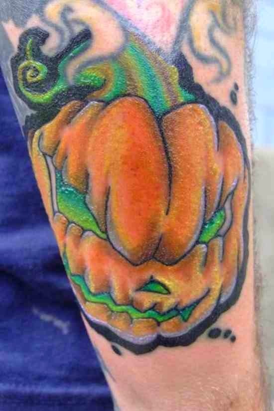 Green And Orange Ink Evil Pumpkin Tattoo On Sleeve