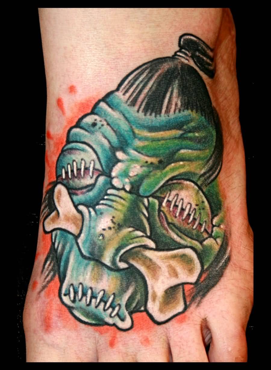 Green Shrunken Head Tattoo On Left Foot by Kretoney