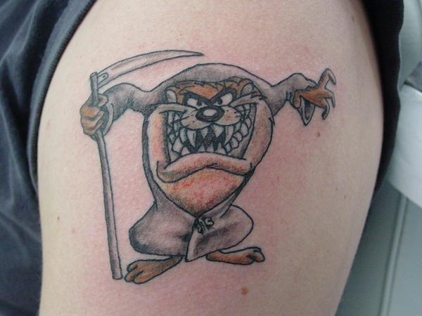 Grey Ink Tasmanian Devil Tattoo On Left Shoulder.