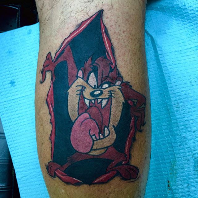 Red And Black Tasmanian Devil Tattoo On Leg